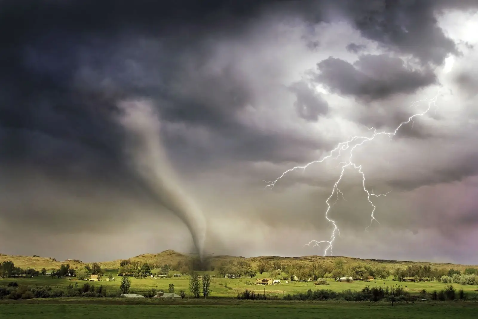 Tornado and lightning over open countryside
